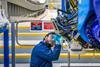 A mechanic prepares to operate the automated fibre placement machine that is building the spars for the wings of the first 777-8F