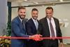 Genaro, Ayman, and Leslie cutting ribbon for Abu Dhabi office opening