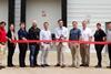 Avflight and Lufthansa team members cutting a ribbon at the Nomads building. Photo: Lufthansa Cargo