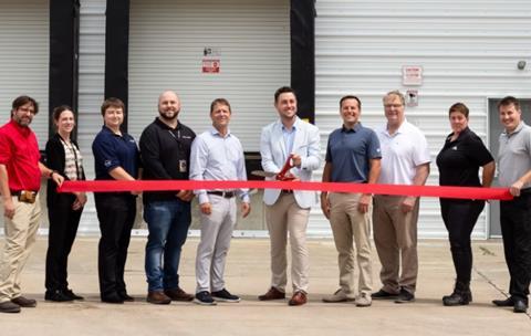 Avflight and Lufthansa team members cutting a ribbon at the Nomads building. Photo: Lufthansa Cargo
