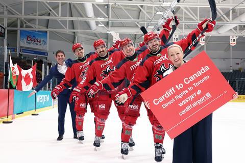 Jon Bridge, chief executive of Cardiff Airport; Rebecca Evans, member of the Welsh Senedd (MS) and cabinet secretary for economy, energy and planning; and Cardiff Devils ice hockey players